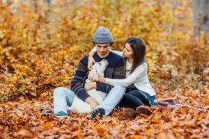beautiful young couple enjoying picnic time forest with golden labrador 1 scaled