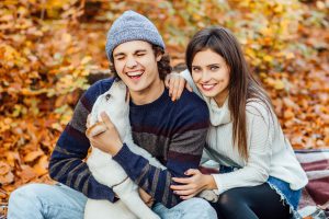 romantic couple with dog sitting autumn forest background with dog 1 scaled